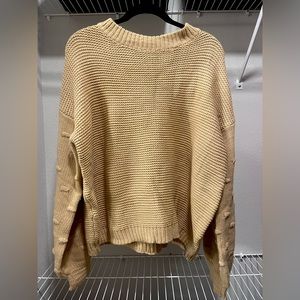 boutique like tan sweater with dotted accents on the arms
